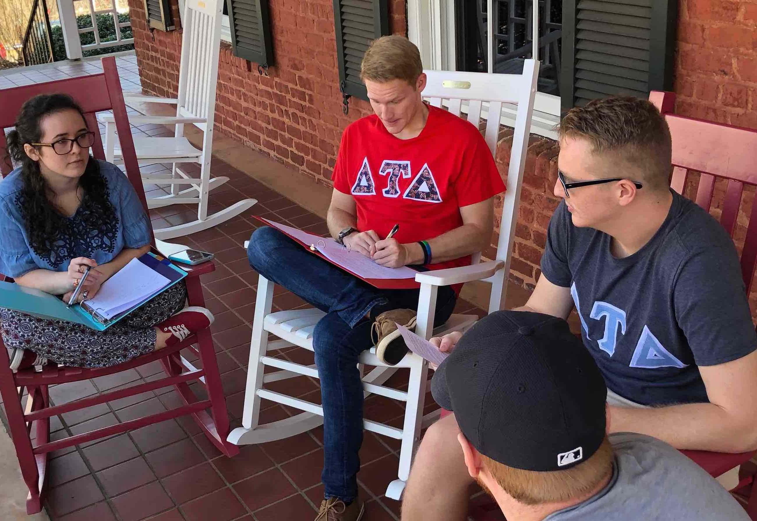 Three young men study outside